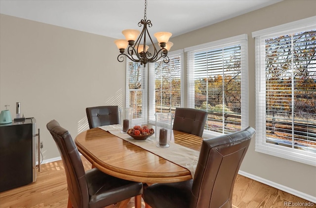 dining space with a chandelier and light wood-type flooring