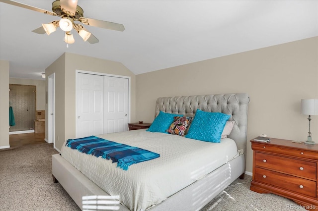 carpeted bedroom featuring ceiling fan, vaulted ceiling, and a closet