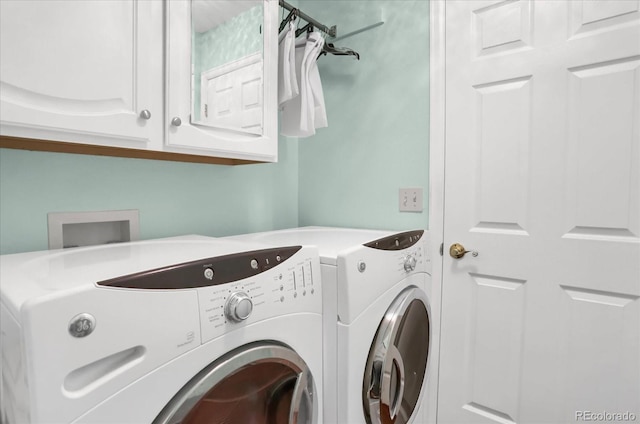 clothes washing area with cabinets and independent washer and dryer