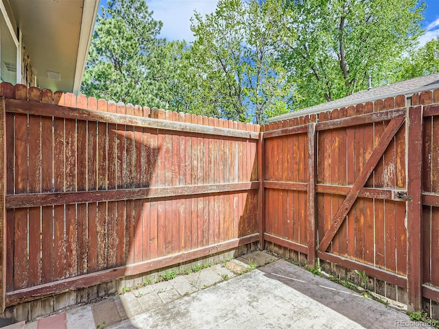 view of gate with a patio