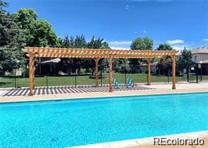 view of swimming pool featuring a pergola