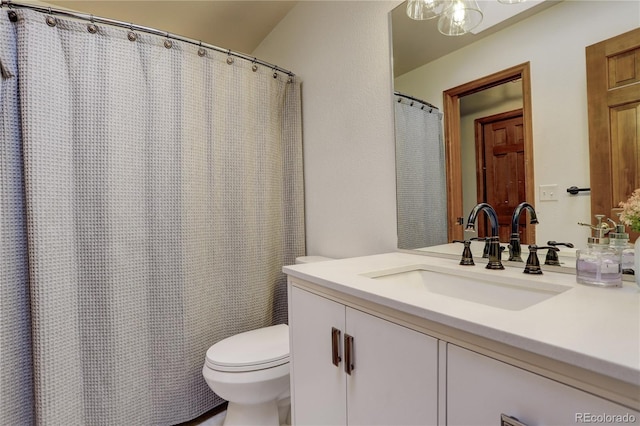 bathroom featuring toilet and vanity