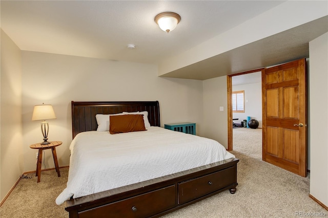 bedroom with light carpet and baseboards