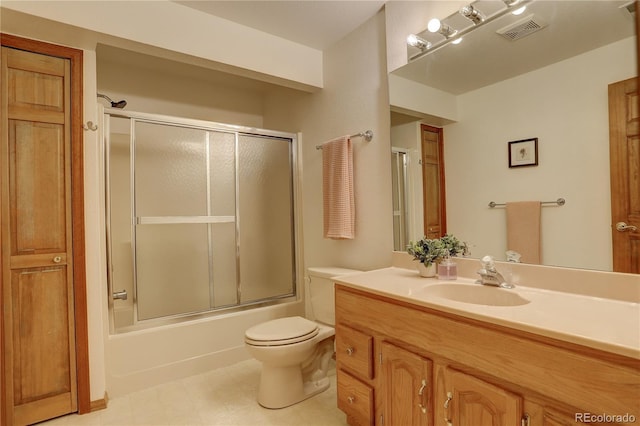 bathroom featuring visible vents, toilet, vanity, and bath / shower combo with glass door