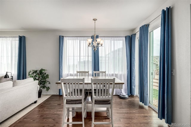 9350 Dunraven St, Arvada, CO 80007 - dining room featuring a chandelier, healthy amount of natural light, and dark wood finished floors
