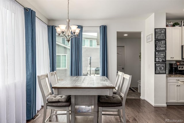 9350 Dunraven St, Arvada, CO 80007 - dining room featuring a chandelier, dark wood-style floors, and baseboards
