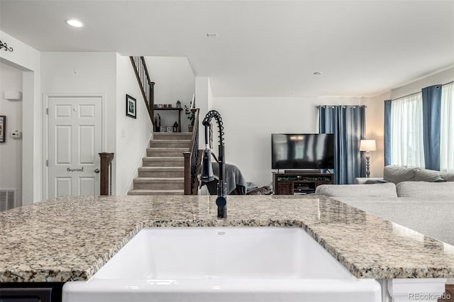 9350 Dunraven St, Arvada, CO 80007 - kitchen featuring open floor plan, a sink, light stone countertops, and recessed lighting