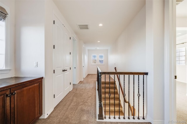 hallway with light carpet