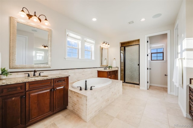 bathroom with tile patterned flooring, vanity, separate shower and tub, and plenty of natural light