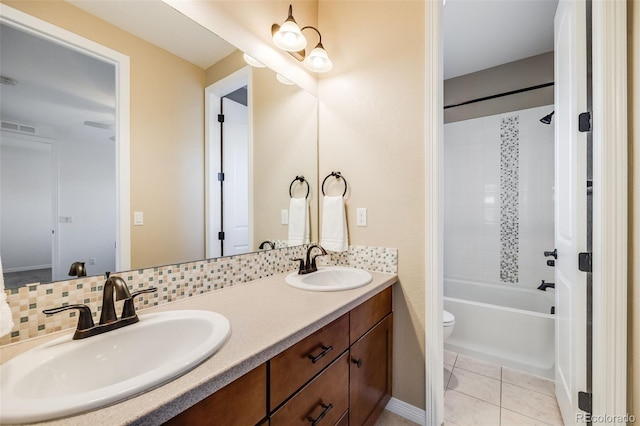 full bathroom featuring decorative backsplash, tile patterned floors, vanity, bathing tub / shower combination, and toilet