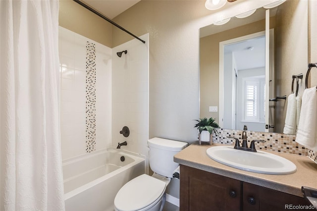 full bathroom with tasteful backsplash, vanity, shower / tub combo, and toilet