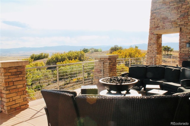 balcony with a mountain view and an outdoor hangout area