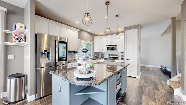 4826 S Ireland St, Aurora, CO 80015 - kitchen with open shelves, stainless steel appliances, white cabinetry, a center island, and dark wood-style floors
