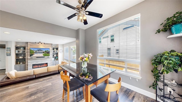 4826 S Ireland St, Aurora, CO 80015 - dining area featuring a tiled fireplace, wood finished floors, a ceiling fan, baseboards, and recessed lighting