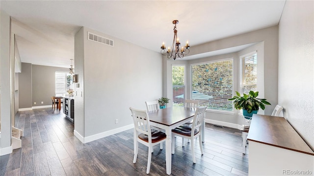 4826 S Ireland St, Aurora, CO 80015 - dining room featuring a chandelier, baseboards, and dark wood-type flooring