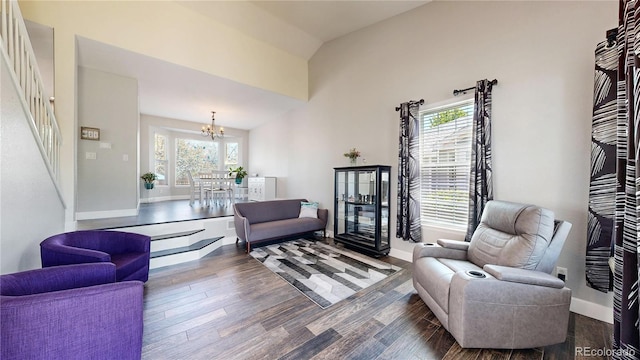 4826 S Ireland St, Aurora, CO 80015 - living room featuring a chandelier, wood finished floors, healthy amount of natural light, and a high ceiling