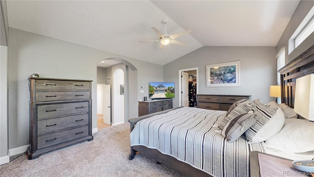 4826 S Ireland St, Aurora, CO 80015 - bedroom featuring arched walkways, light carpet, baseboards, vaulted ceiling, and a spacious closet