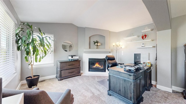 4826 S Ireland St, Aurora, CO 80015 - office featuring a glass covered fireplace, plenty of natural light, light carpet, baseboards, and vaulted ceiling
