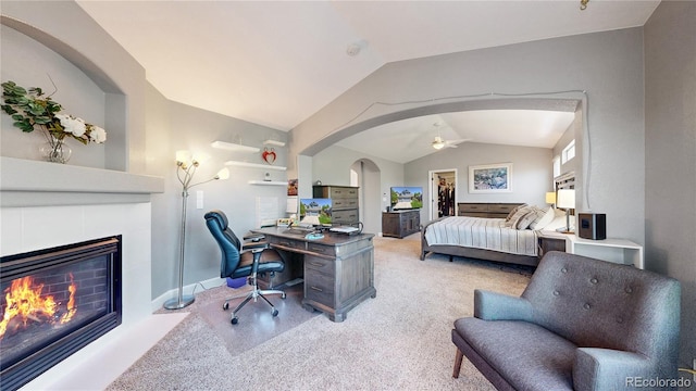 4826 S Ireland St, Aurora, CO 80015 - bedroom featuring lofted ceiling, a tile fireplace, a spacious closet, arched walkways, and a desk