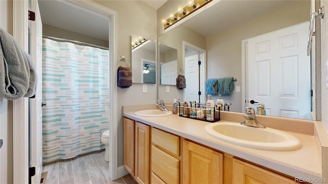 4826 S Ireland St, Aurora, CO 80015 - bathroom with toilet, double vanity, and curtained shower