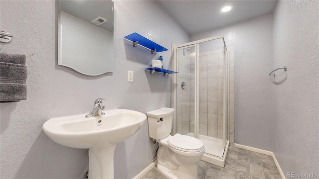 4826 S Ireland St, Aurora, CO 80015 - full bathroom featuring toilet, a shower stall, baseboards, stone finish flooring, and a textured wall