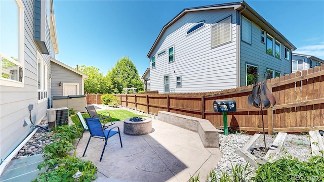 4826 S Ireland St, Aurora, CO 80015 - fenced backyard featuring central AC unit, an outdoor fire pit, and a patio area