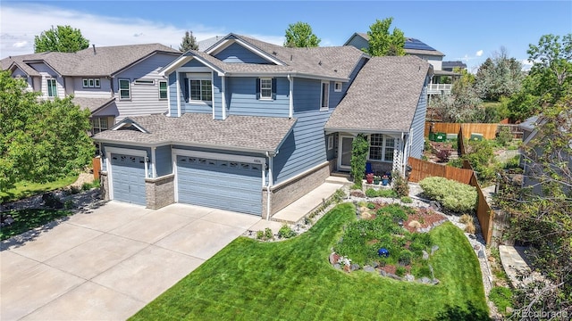 4826 S Ireland St, Aurora, CO 80015 - view of front of house featuring concrete driveway, brick siding, roof with shingles, and an attached garage
