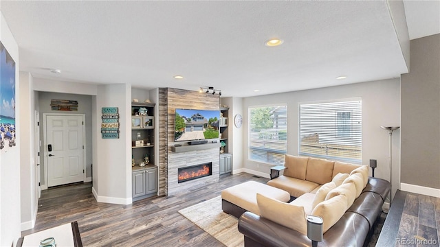 4826 S Ireland St, Aurora, CO 80015 - living area featuring baseboards, wood finished floors, a tiled fireplace, and recessed lighting