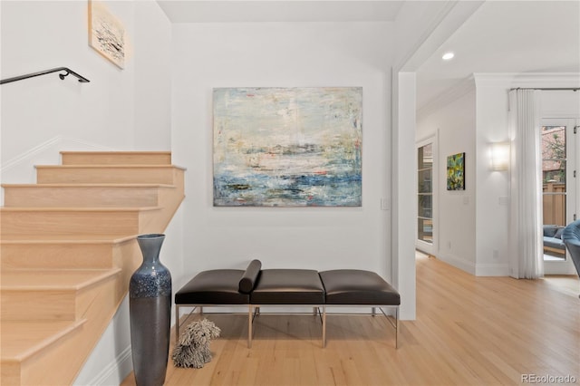 stairs featuring recessed lighting, crown molding, baseboards, and wood finished floors