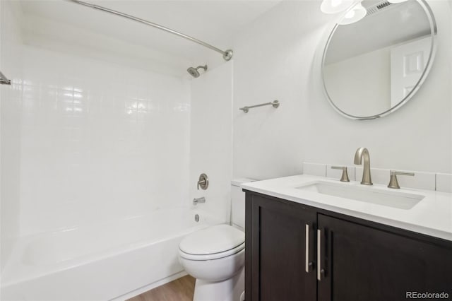 bathroom featuring toilet, shower / bath combination, vanity, and wood finished floors