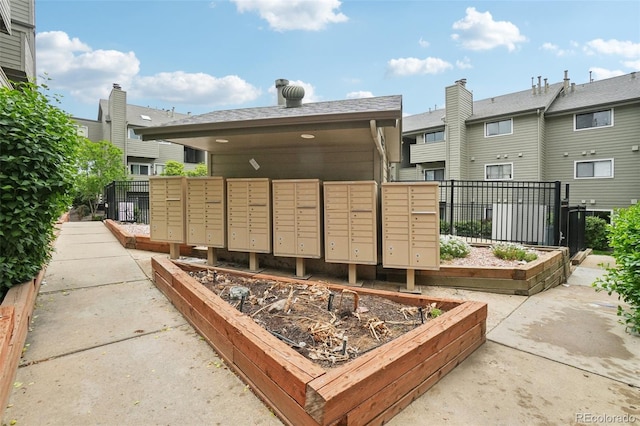 surrounding community with mail area and fence