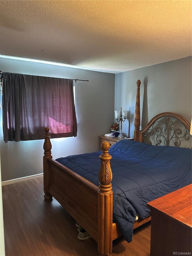 19645 E Buchanan Pl, Aurora, CO 80011 - bedroom with wood finished floors and a textured ceiling