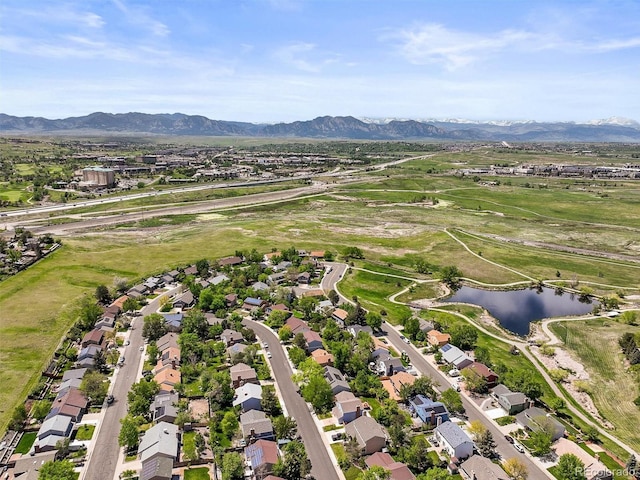 aerial overview of property's location featuring a water and mountain view and nearby suburban area