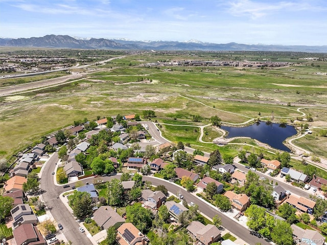aerial overview of property's location with a water and mountain view and nearby suburban area