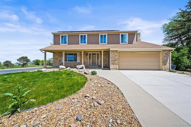 traditional home with a porch, driveway, roof mounted solar panels, a garage, and brick siding