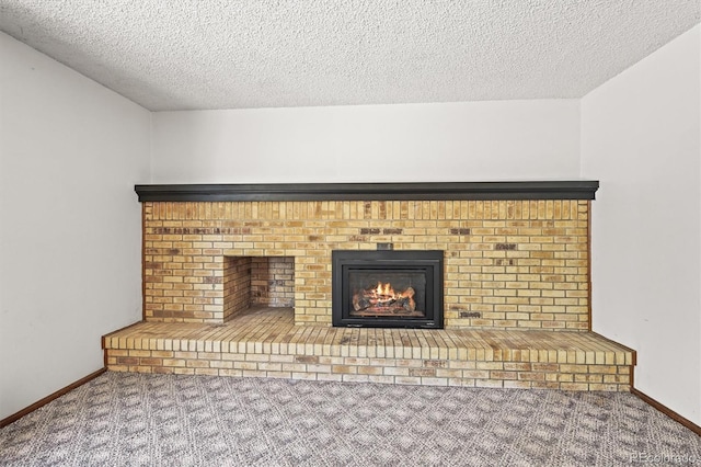 detailed view of carpet, a brick fireplace, a textured ceiling, and baseboards