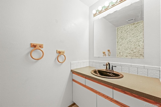 bathroom with vanity and backsplash