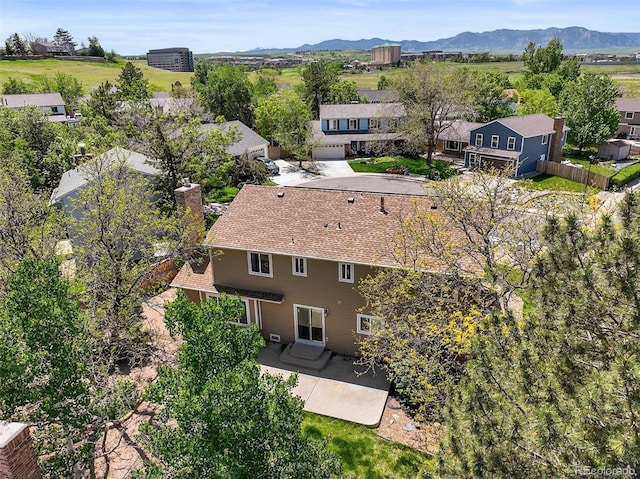 aerial view of property and surrounding area featuring a mountain backdrop