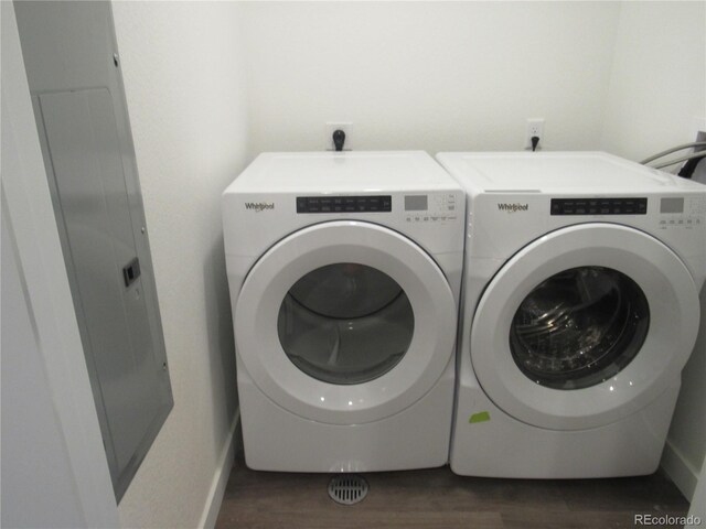 clothes washing area with separate washer and dryer and dark hardwood / wood-style floors