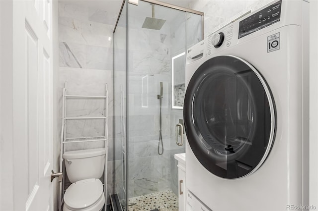 bathroom with toilet, washer / dryer, walk in shower, and vanity