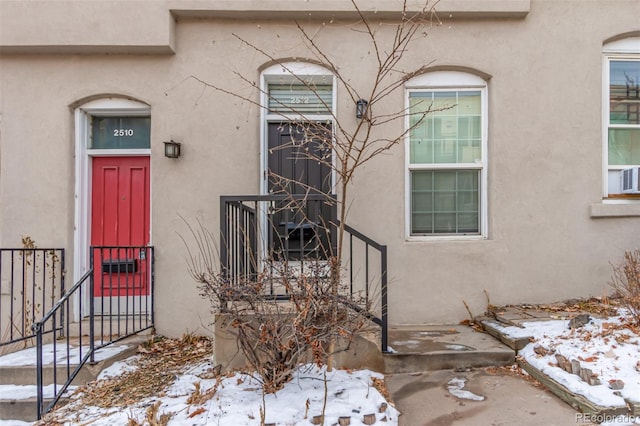 view of snow covered property entrance