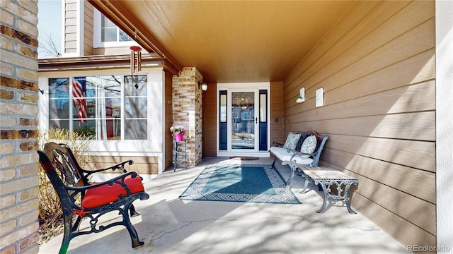 entrance to property featuring brick siding