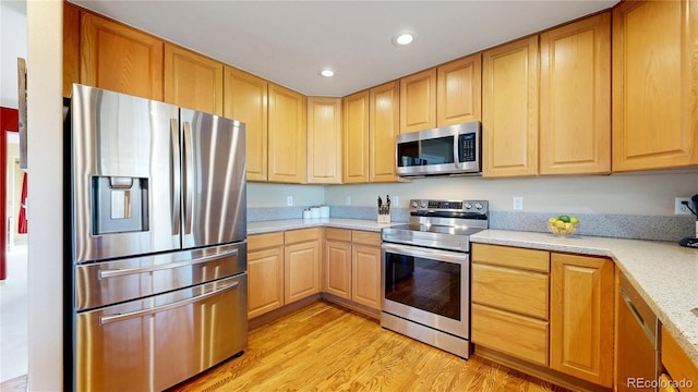 kitchen with stainless steel appliances, light wood finished floors, light brown cabinets, and recessed lighting