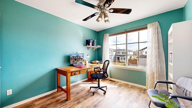 office space with a ceiling fan, baseboards, and wood finished floors