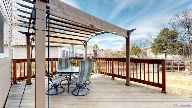 wooden deck with outdoor dining area, fence, and a pergola