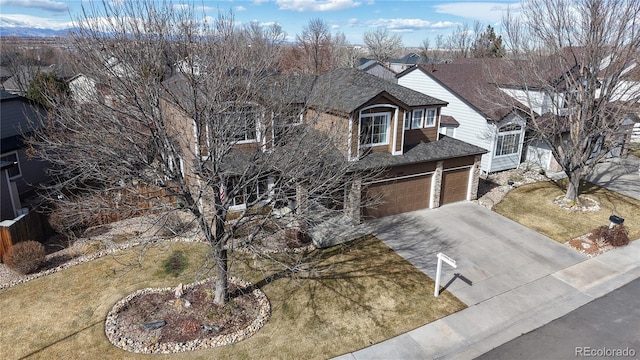 view of front of house featuring a garage, a shingled roof, a front lawn, and concrete driveway