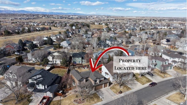 birds eye view of property with a residential view and a mountain view