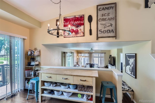 1201 Trout Creek Cir, Longmont, CO 80504 - kitchen featuring a chandelier, light countertops, hanging light fixtures, a kitchen breakfast bar, and ceiling fan