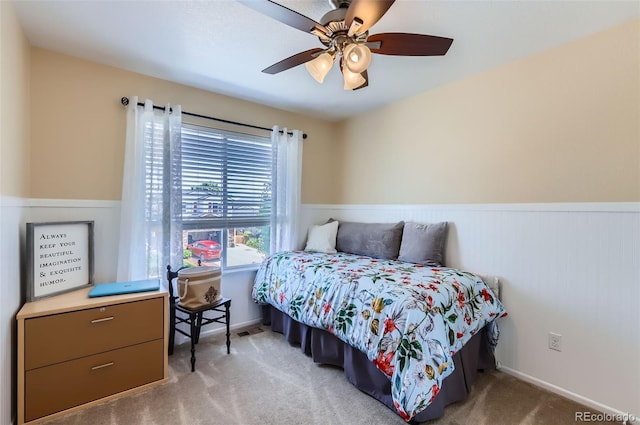 1201 Trout Creek Cir, Longmont, CO 80504 - bedroom with wainscoting, carpet floors, and a ceiling fan