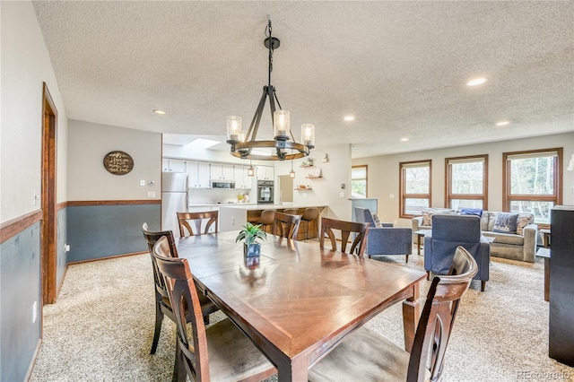 140 Forest Dr, Frisco, CO 80443 - dining area featuring a textured ceiling, a chandelier, healthy amount of natural light, light carpet, and recessed lighting